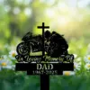 Black memorial silhouette of a motorcyclist kneeling by a cross and sportbike with text "In Loving Memory Of DAD 1967-2025" over a blurred daisy field background