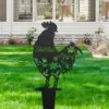 Black metal rooster yard stake with floral cutouts and the name “Skittles” displayed, planted in a green lawn in front of a white house