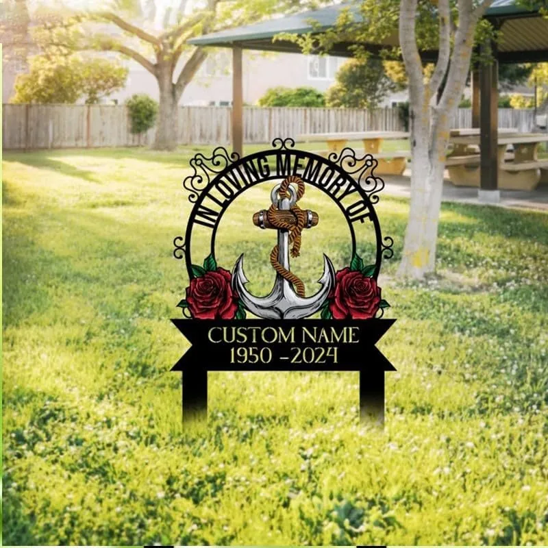 Memorial yard sign with anchor, rope and roses reading "In Loving Memory" and placeholder text "CUSTOM NAME 1950–2024" staked in a sunny park lawn