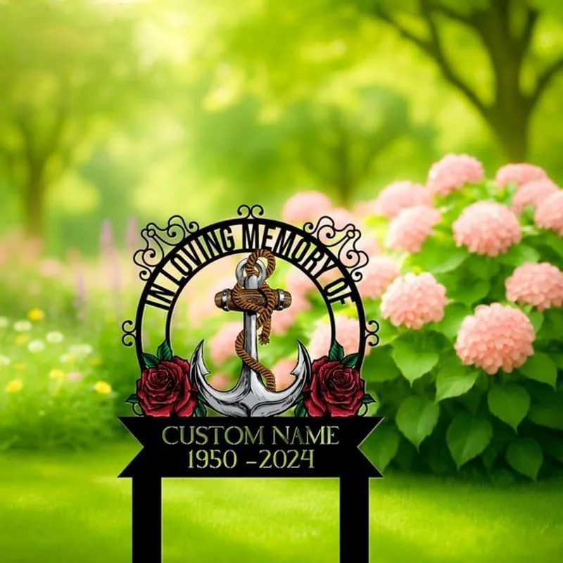 Decorative memorial garden stake with an anchor, roses and text reading "In Loving Memory of" and placeholder "Custom Name 1950-2024" placed in a green lawn near pink hydrangeas