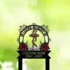 Black memorial sign reading "In Loving Memory" with an anchor wrapped in rope, red roses and a banner showing "Custom Name 1950-2024" against a soft green bokeh background