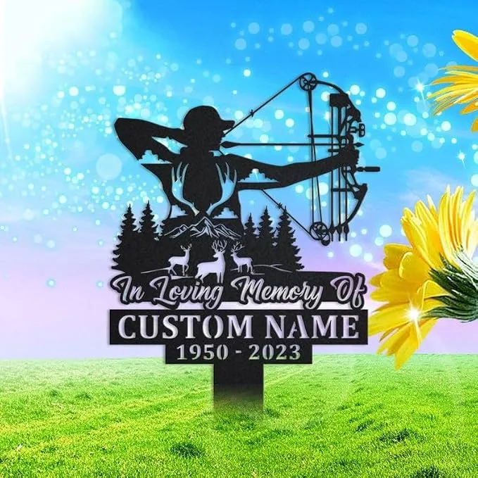 Outdoor memorial yard sign showing a silhouette of an archer with bow above pine trees and deer, text reading "In Loving Memory Of" and placeholder "CUSTOM NAME 1950-2023" against a bright sky and grassy lawn