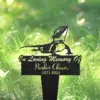 Black metal garden memorial stake with a lizard silhouette and script text reading "In Loving Memory Of Parker Chavis 1971-2024" placed in green grass