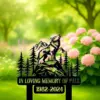 232-2 Black metal memorial sign with a howling wolf on a rock among pine trees and mountains, text reads “In Loving Memory of Paul 1982-2024,” set against a blurred garden with pink hydrangeas.