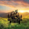 Memorial metal sign showing a howling wolf on a rock with pine trees and mountains, text "In Loving Memory of Paul 1982–2024" over a grassy sunrise landscape