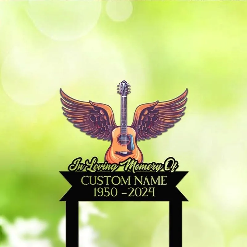 Memorial sign mockup with winged acoustic guitar graphic and text reading "In Loving Memory Of" and placeholder "CUSTOM NAME 1950-2024" on a soft green bokeh background