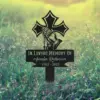 251-1 Black memorial stake in grassy field with praying hands, rosary, cross, and text "In Loving Memory of Amalan Robinson 1962 - 2025"