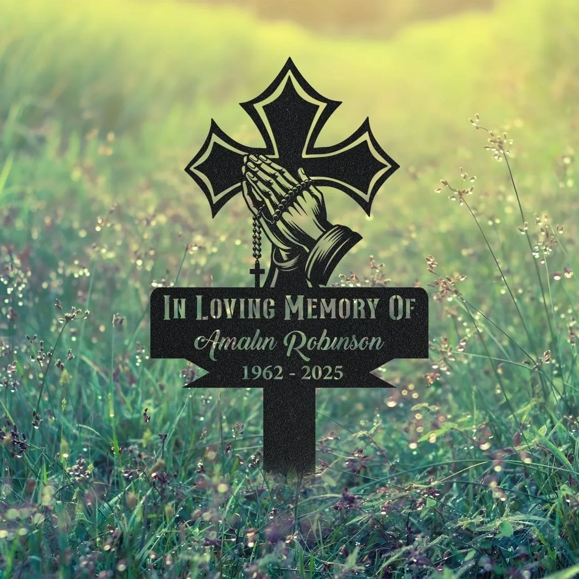 251-1 Black memorial stake in grassy field with praying hands, rosary, cross, and text "In Loving Memory of Amalan Robinson 1962 - 2025"