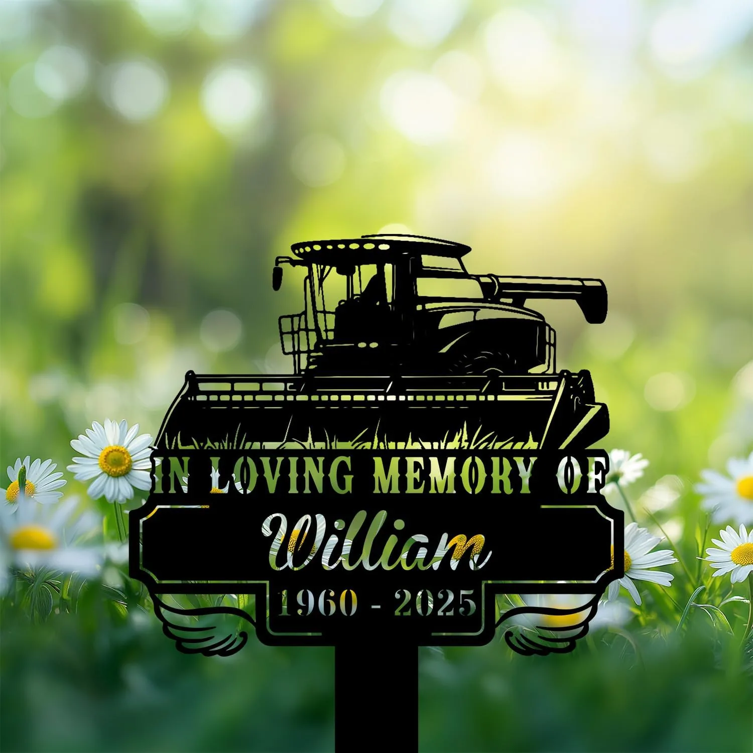 264 Black memorial sign with a combine harvester silhouette reading "In Loving Memory of William 1960 - 2025" placed in a sunlit daisy-filled green field