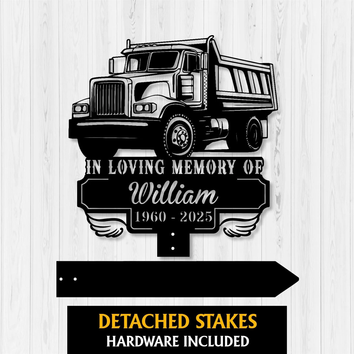 Black metal memorial sign showing a dump truck with text 'In Loving Memory of William 1960 - 2025' on a light wood background