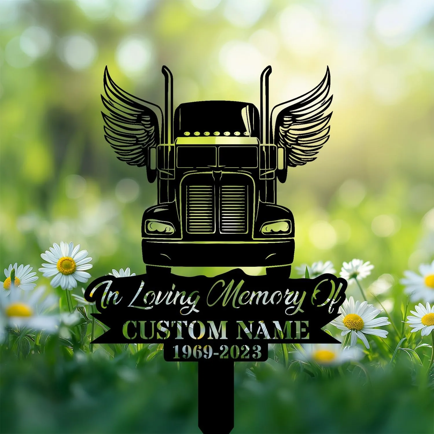 Black silhouette memorial sign of a winged semi truck with daisies and blurred green bokeh background, text area reading "In Loving Memory Of" and placeholder "CUSTOM NAME 1969-2023"