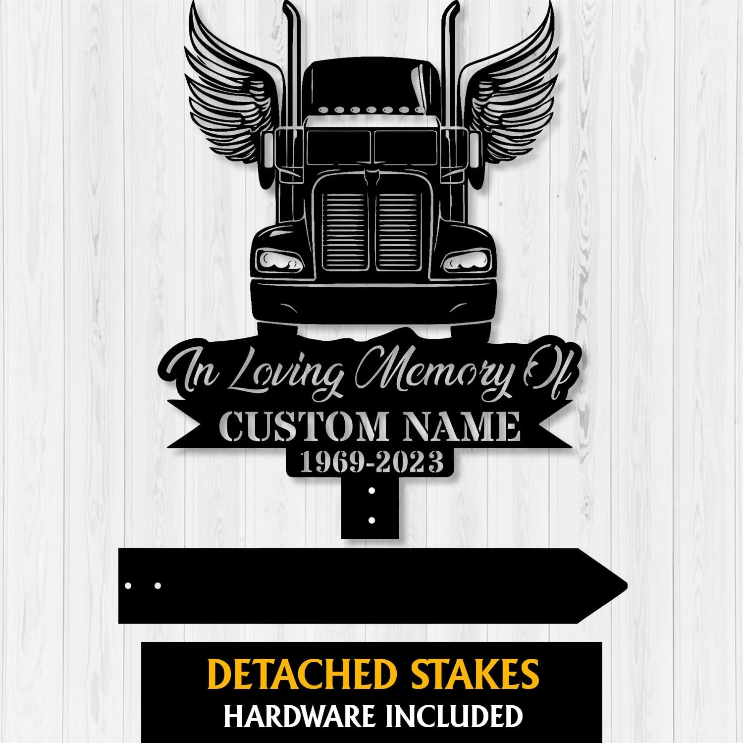 Black metal memorial sign showing front of a semi truck with wings and text reading "In Loving Memory Of" and placeholder "CUSTOM NAME 1969-2023" on a white wood background