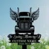 Black silhouette memorial sign of a semi truck with wings above script text “In Loving Memory Of” and placeholder “CUSTOM NAME 1969-2023” against a blue sky and dandelion field