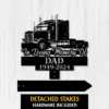Black metal memorial sign with a semi truck silhouette reading "In Loving Memory Of DAD 1949-2024" on a light wood background