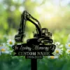 Black silhouette memorial sign of an excavator with text placeholder "In Loving Memory Of" and "CUSTOM NAME 1969-2023" set among daisies in a sunlit green field