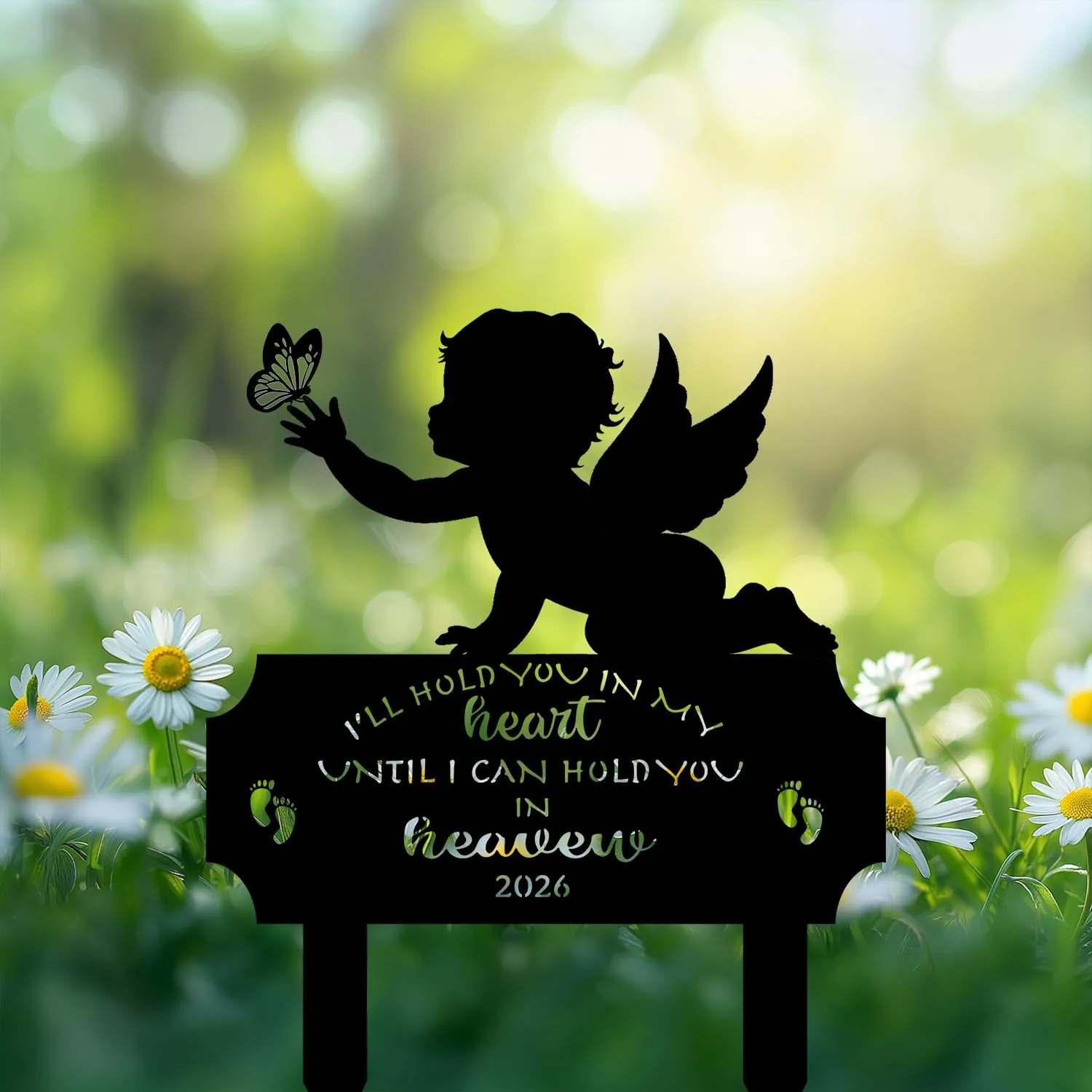 Black silhouette garden memorial stake of a winged baby reaching for a butterfly above daisies, text reads "I'll hold you in my heart until I can hold you in heaven 2026"