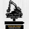 Black metal memorial sign with excavator graphic reading "In Loving Memory Of" and placeholder "CUSTOM NAME 1969-2023" shown on a light wood background