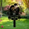 343 Black metal memorial yard sign in a garden showing parents holding an angelic baby with text “In Loving Memory of Bean Baby 2025”