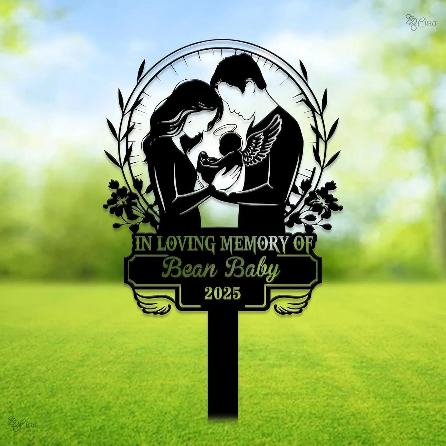 344 Black memorial yard sign showing a silhouetted couple holding an angel-winged baby with text "In Loving Memory of Bean Baby 2025" against a blurred green lawn background
