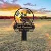 354 Memorial metal sign in a field at sunset reading “In Loving Memory of Jacob Henderson 1956 - 2024” with a motocross rider and checkered flags inside a circular frame