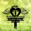 Black memorial yard sign with a heart, angel wings and baby footprints reading "In Loving Memory Of" and placeholder "Custom Name" with dates 2020 - 2025 on green grass background