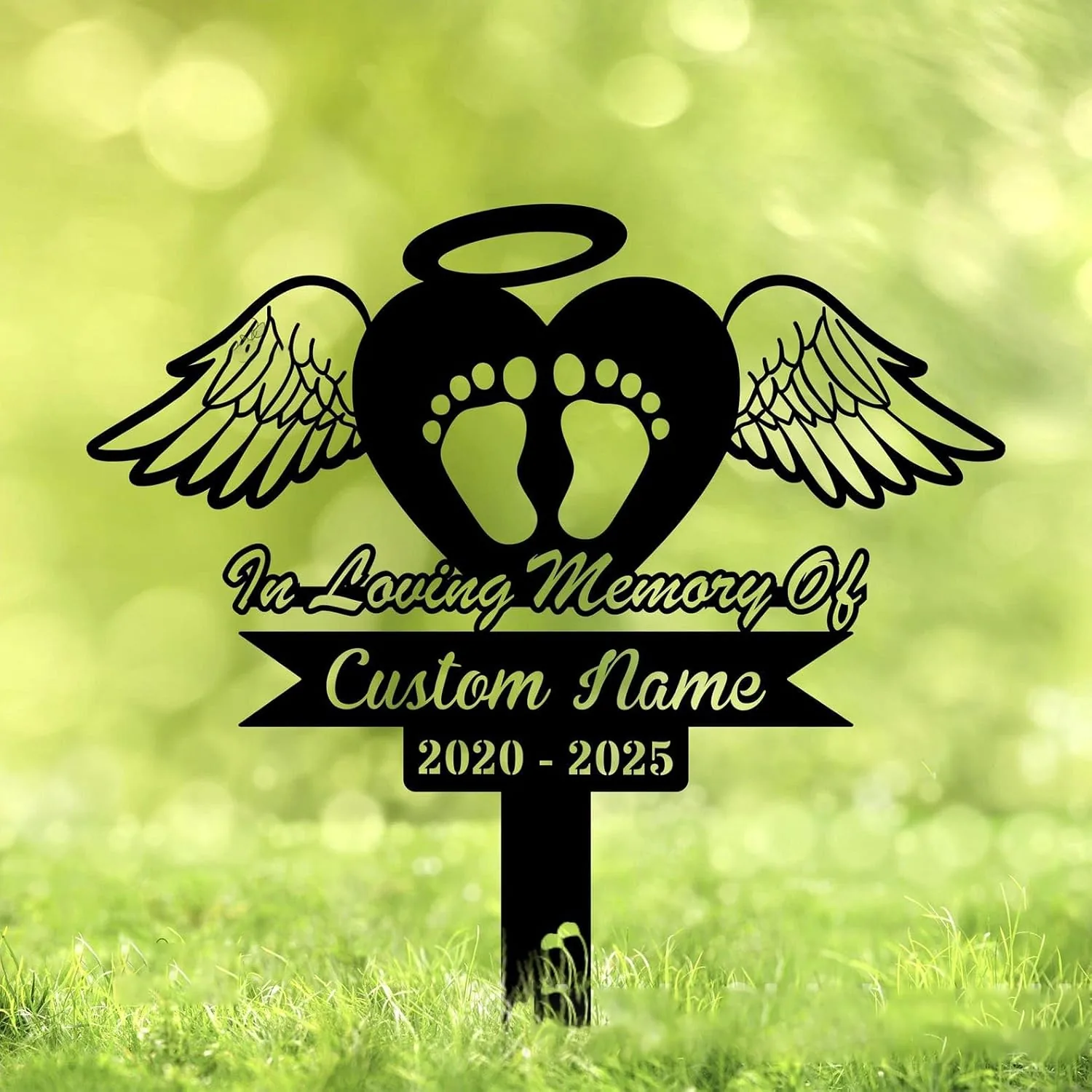 Black memorial yard sign with a heart, angel wings and baby footprints reading "In Loving Memory Of" and placeholder "Custom Name" with dates 2020 - 2025 on green grass background
