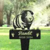 Black metal pet memorial stake in a park featuring a guinea pig illustration, the name “Bandit” and years “2020-2024” with paw prints