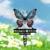 43 Colorful butterfly grave marker with decorative wings, placeholder text "CUSTOM NAME" and dates "2002-2024" over a grassy daisy field