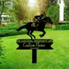 Black metal memorial yard sign with a jockey on a galloping horse above text reading "In Loving Memory Of" and customizable name and dates, staked in a green lawn with trees and landscaping in the background