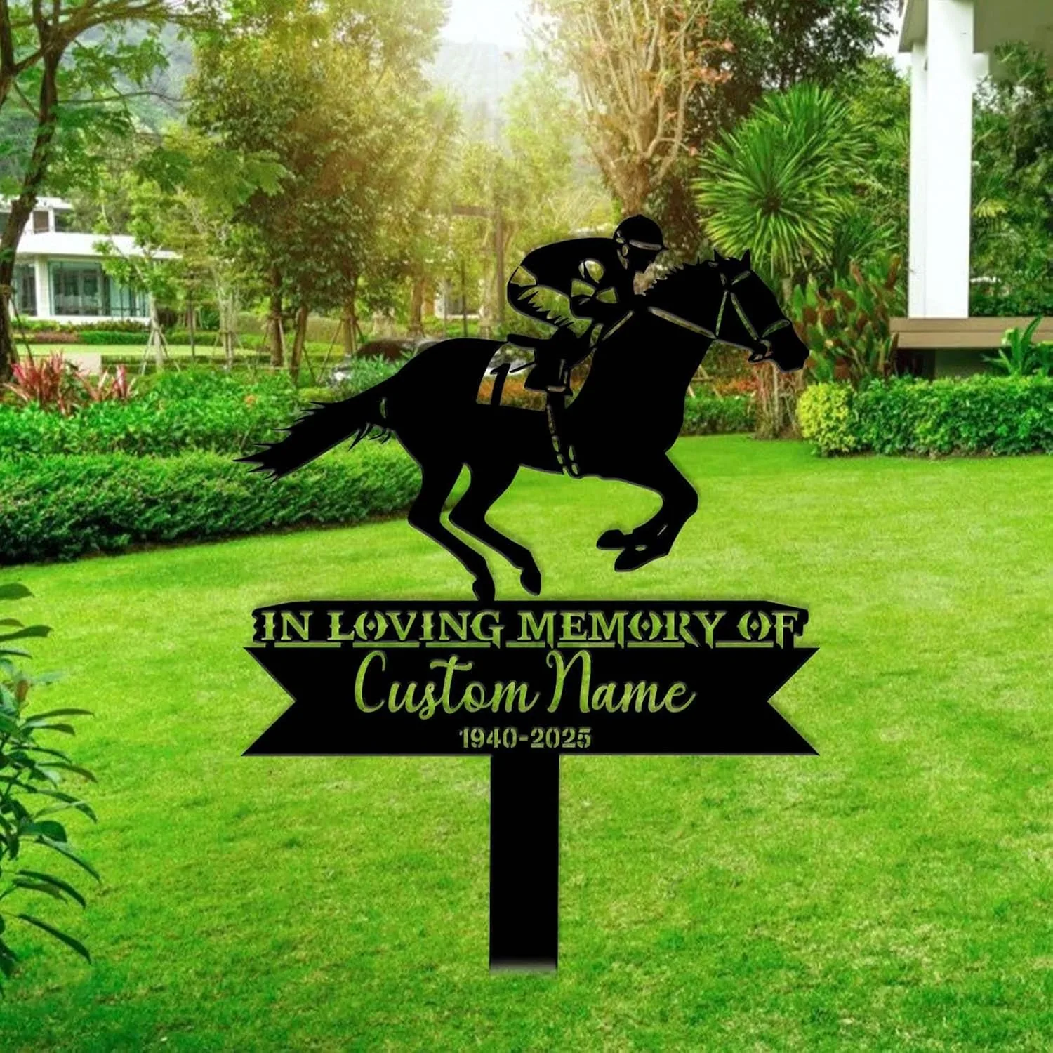 Black metal memorial yard sign with a jockey on a galloping horse above text reading "In Loving Memory Of" and customizable name and dates, staked in a green lawn with trees and landscaping in the background