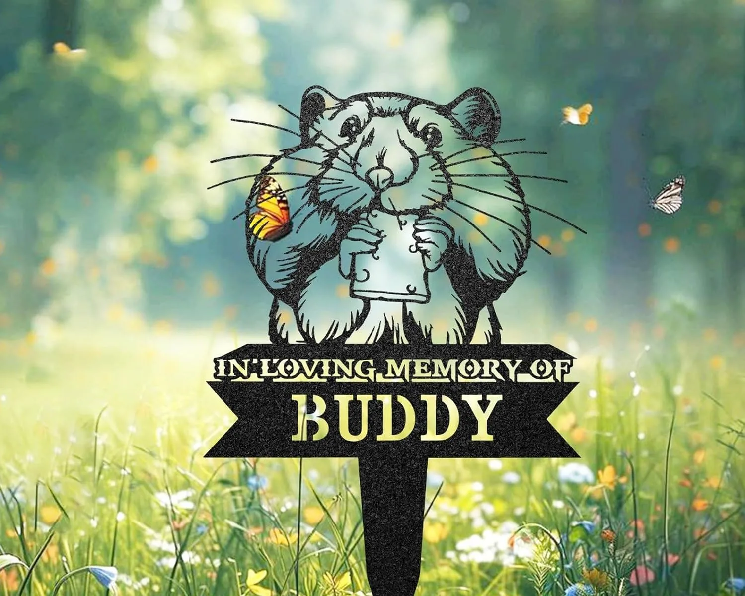 82-1 Garden memorial stake showing a cartoon hamster holding a cup with text "In Loving Memory of Buddy" against a sunny meadow background