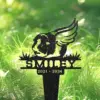 91-1 Black metal memorial stake with a winged dog head silhouette, name "SMILEY" and years "2021 - 2024" set in green grass