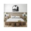 style-16.-Motorboat-Couple-3 Rustic bedroom with wooden bed and bedside tables, metal wall art above headboard showing boat, couple silhouette, sun and the text "Jack & Jasmine"