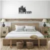 style-20.-Farmer-Tractor-Couple-3 Rustic bedroom with wooden bed, nightstands and lamps, wall sign above bed reading "Josh & Amy" with tractor silhouette and date