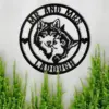 Black metal wall sign with two wolf heads and text 'MR AND MRS ZADOUGH' mounted on a light wall above green plants