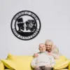 style-23.-Gothic-Skeleton-Couple-2 Elderly couple sitting on a yellow couch under a round black metal wall sign reading "Morris & Mary 50th Anniversary" in a bright living room