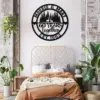 style-25.-Deer-Couple-3 Black circular metal wall sign reading “Morris & Mary 60 Years Together Est. 1963” with deer and trees, hanging above a boho bedroom bed with plants