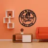 style-29.-Parrot-Couple-2 Modern living room with orange wall and sofa, black round metal sign reading "Jesse & Cheryl 50 Years Together Est. 1974" above a wooden coffee table and white cube shelves.