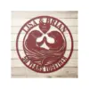 style-35.-Otter-Anniversary-2 Red circular metal wall sign with two otters facing each other, heart reading "EST. 1974," names "LISA & BRIAN" across top and "50 YEARS TOGETHER" along bottom, on whitewashed wood background