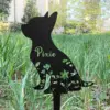 372 Black metal cat garden stake with floral cutouts and the name “Pixie,” placed in grassy outdoor lawn near trees and buildings