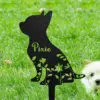 373 Black metal dog silhouette yard stake with floral cutouts and the name "Pixie" staked in green grass next to a small white puppy
