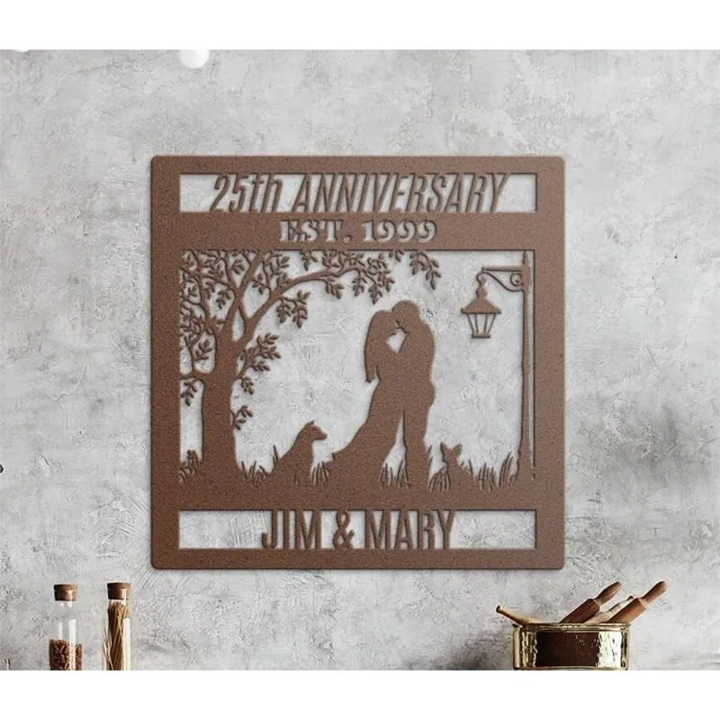 style-37.-Autumn-Dog-Cat-2 Rust-colored metal wall art reading "25th Anniversary EST. 1999" with silhouette of a couple kissing under a tree, two dogs, a lamp, and the names "Jim & Mary" mounted on a concrete wall