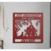 Red metal wall plaque reading "50th Anniversary Est. 1974" with silhouetted couple on a bench, dog, tree, lamp, and names "Jim & Mary" hung on a light wall