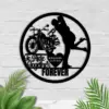 Round black metal wall art showing a motorcycle and a kissing couple silhouette with text 'Born To Ride Together Forever' and a heart labeled 'WILLIAMS 02.02.2005' on a white brick wall